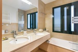 a bathroom with two sinks and a large mirror at El Oasis Martinica 8 1A in Fuente Alamo +20 photos