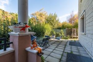 a gnome sitting on a pillar on a patio at Casaentino in Capolona