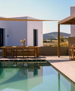 a villa with a swimming pool and a house at ANOTERRA VILLAS -Anemone in Ambelas