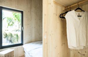 a robe hanging on a wall in a room with a window at mini mal anders in Altmannstein