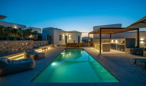 a villa with a swimming pool at night at ANOTERRA VILLAS -Anemone in Ambelas +57 photos