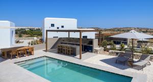 a villa with a swimming pool and a house at ANOTERRA VILLAS -Anemone in Ambelas
