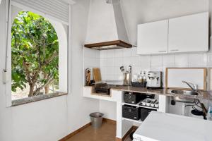a kitchen with white appliances and a window at Appartment Patricia in Orba