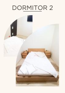 two beds in a room with the words durator at Casa M&R in Bucharest