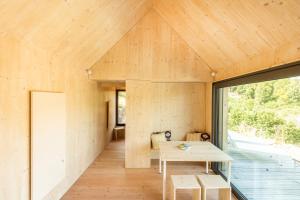 a room with a table and a large window at mini mal anders in Altmannstein