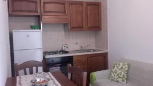 a small kitchen with a sink and a stove top oven at da Ciccio e Concy in Tursi
