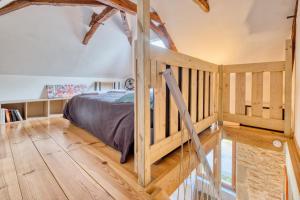 Sainte-OrseにあるGite À La Fermeのベッドと木の床のある寝室