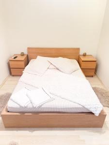 a bedroom with a bed with two night stands at Casa M&R in Bucharest +11 photos