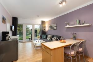 a kitchen and living room with a table and chairs at Panorama Schönberg 02 in Schönberg +23 photos