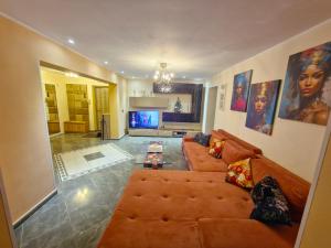 a living room with a couch and a table at Apartament Superb in Onești +3 photos