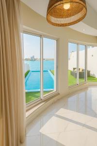 a large room with windows and a view of the ocean at درة العروس فيلا نجمة البحر in Durat Alarous