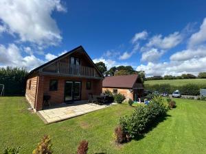 a small brick house with a large yard at Beechen Lodges in Bishops Waltham