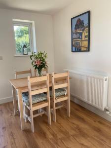 a dining room with a wooden table and chairs at Beechen Lodges in Bishops Waltham +5 photos