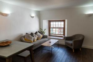 a living room with a couch and a table at Mor Ki -A perfectly situated modern flat in Looe in Looe