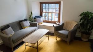 a living room with a couch and two chairs and a table at Mor Ki -A perfectly situated modern flat in Looe in Looe