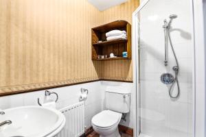 a bathroom with a toilet and a sink and a shower at The Honest Lawyer, an Ascend Collection Hotel in Nelson +30 photos