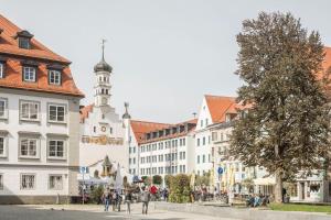 a street in a town with buildings and a tower at Appartement Rathausplatz in Kempten