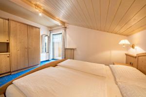 a bedroom with a large bed with a wooden ceiling at Residence Kronstein - Fewo 8 in Tesimo