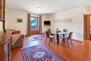a living room with a table and chairs at Cima de' Piazzi Apartment 1 in Isolaccia