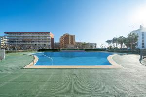 ラ・ピネーダにあるPromar 323の建物を背景にした青い大型スイミングプール
