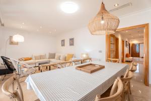 a living room with a table and a couch at Unique Patacona in Valencia