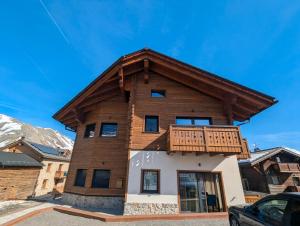 a house with a balcony on top of it at Chalet Kb in Livigno
