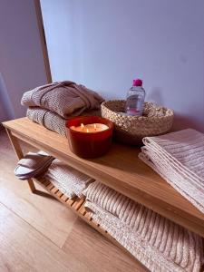 a table with a candle and some towels on it at La Mezzanine - Chambre avec Spa in Bellaing +9 photos