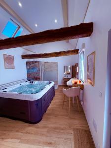 a large master bedroom with a large hot tub at La Mezzanine - Chambre avec Spa in Bellaing