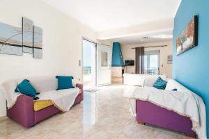 a living room with two beds and a couch at Blue Pearl Apolakkia in Apolakkiá