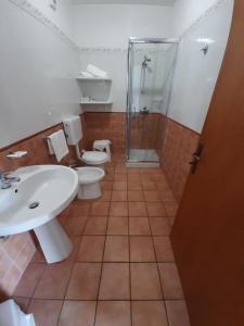 a bathroom with two toilets and a shower and a sink at Messapia Hotel in Marina di Leuca +127 photos