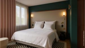 a bedroom with a large white bed and a window at Hotel 2M, The Originals Relais in Saint-Just-Saint-Rambert