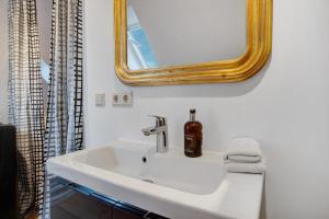 une salle de bain avec un lavabo blanc et un miroir dans l'établissement Corbusier, à Groß Wokern 13 autres photos