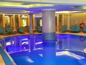 a pool in a hotel lobby with chairs and a hotel at Motel Rest in Przemyśl
