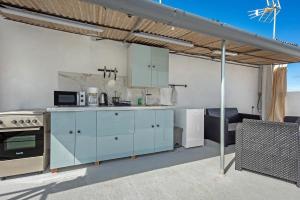 cocina con armarios azules y sala de estar. en Apartamento Vista, en La Orotava 17 fotos más