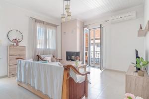 a living room with a table and a couch at Vretto's Home Meganisi in Spartokhórion