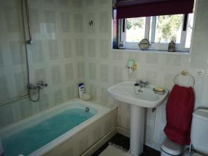 a bathroom with a bath tub and a sink at Shakti Rio Mino in San Bartolomé +36 photos