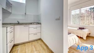 a kitchen with white cabinets and a window at Costacabana - Villa Pilar in Lloret de Mar +36 photos