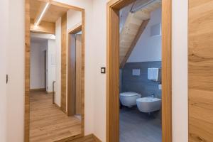 a bathroom with a white tub and a toilet at Kamerloy Apartments G in Campitello di Fassa +23 photos