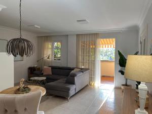 ein Wohnzimmer mit Sofa und Tisch in der Unterkunft Preciosa Casa Con Jardín Privado in Puerto de la Cruz