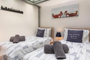 two beds sitting next to each other in a room at Sandy Castle in Southwold
