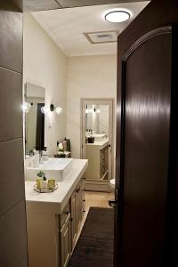 a bathroom with a white sink and a mirror at A Casa dos Raminhos in Vila de Frades