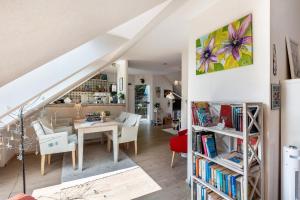 a living room and dining room with a table and chairs at Ferienwohnung Am Jakobsweg in Schmallenberg