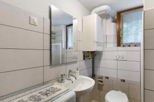 a white bathroom with a sink and a toilet at La Casa dei Cervi a Vinigo in Vodo Cadore +36 photos