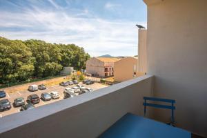 a balcony with a view of a parking lot at Appartement 113 in Cogolin