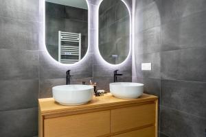 a bathroom with two sinks and two mirrors at Maison 6pers 3kms de la plage in Saint-Jean-de-Monts +27 photos