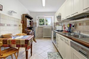 a kitchen with a sink and a counter top at Residenza ai Noci in Lanzo dʼIntelvi