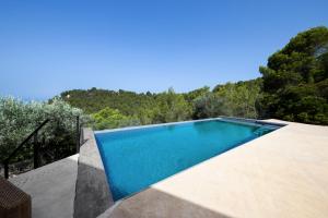 a swimming pool on the side of a house at Dream Property in Alconasser in Sóller