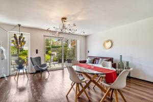 a dining room and living room with a table and chairs at vinum - schlosserhaus 31 in Tesimo