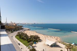 a view of a beach with people in the water at La dimora sul mare in Bari