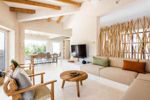 a living room with a couch and a table at Villa Bini Mapa in Binibeca
